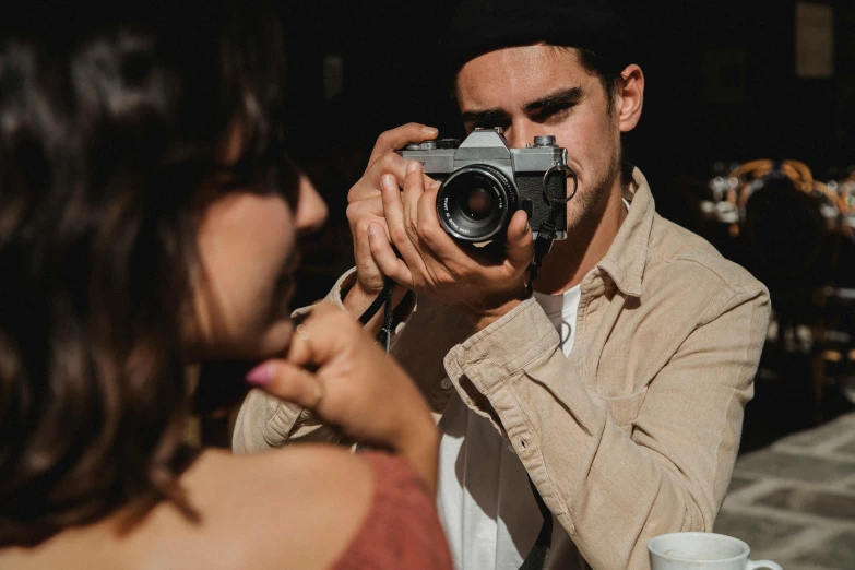 a man holding a camera up to his face