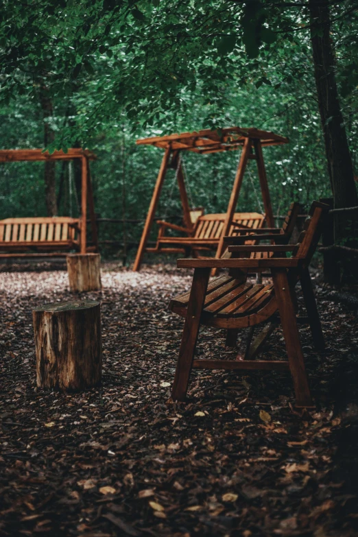 the swings are all wooden and made out of wood logs