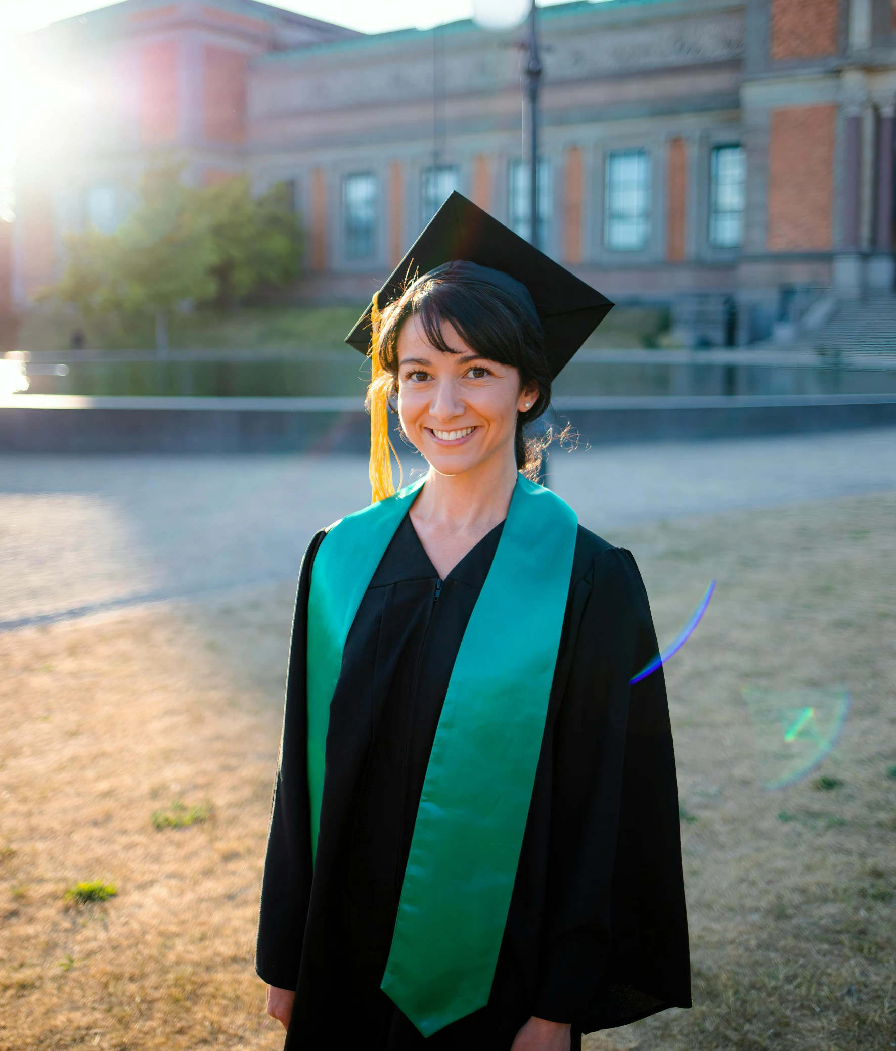 a woman with a graduation cap and gown is smiling