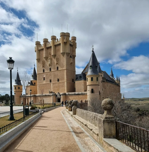 an old castle with a lot of windows near a gate