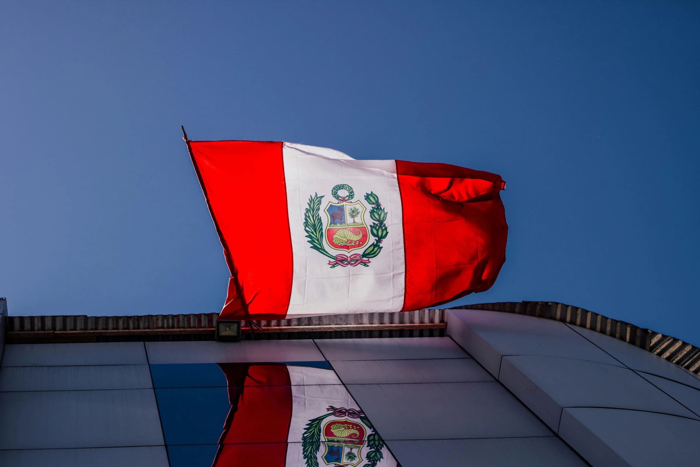 a flag flying on top of a building