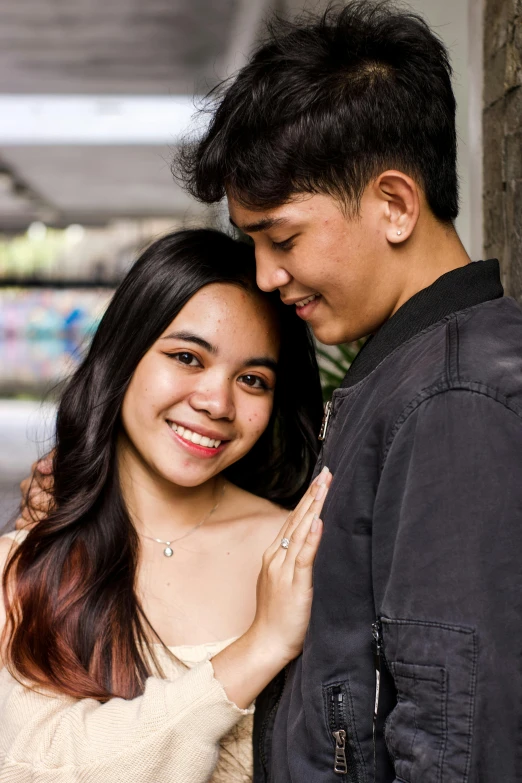 a man and woman smiling next to each other