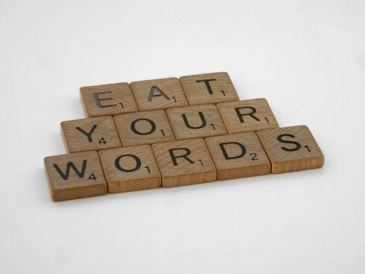 a keyboard with the words eat your words spelled out in scrabble type