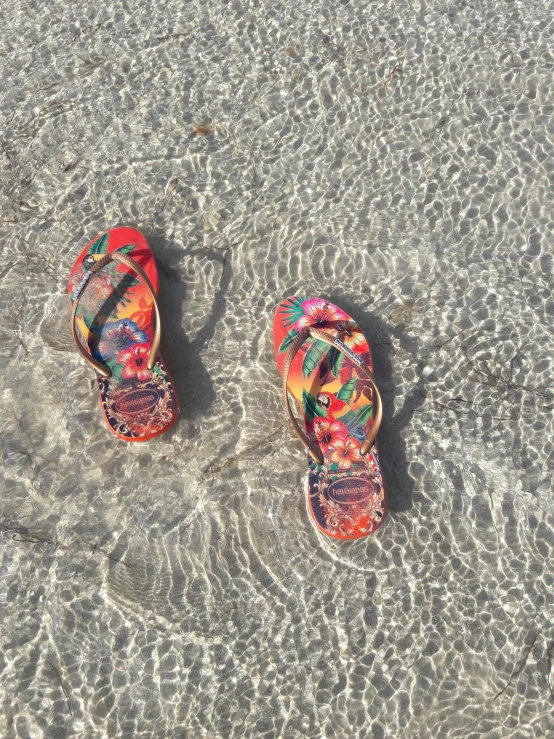 two shoes are sitting on the beach sand