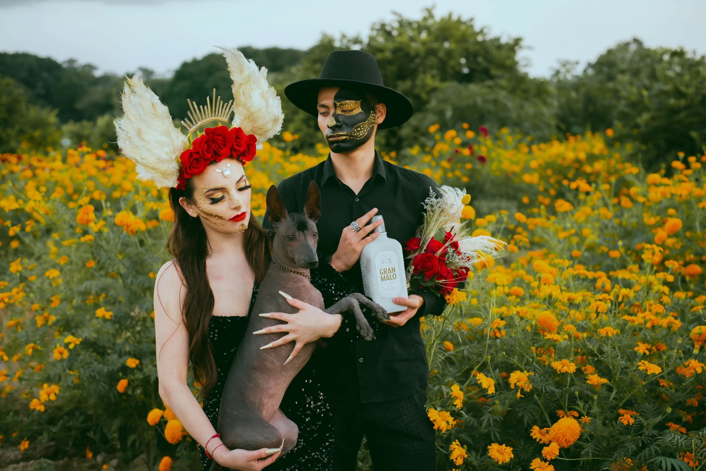 man in a skeleton mask with his girlfriend in a field of flowers