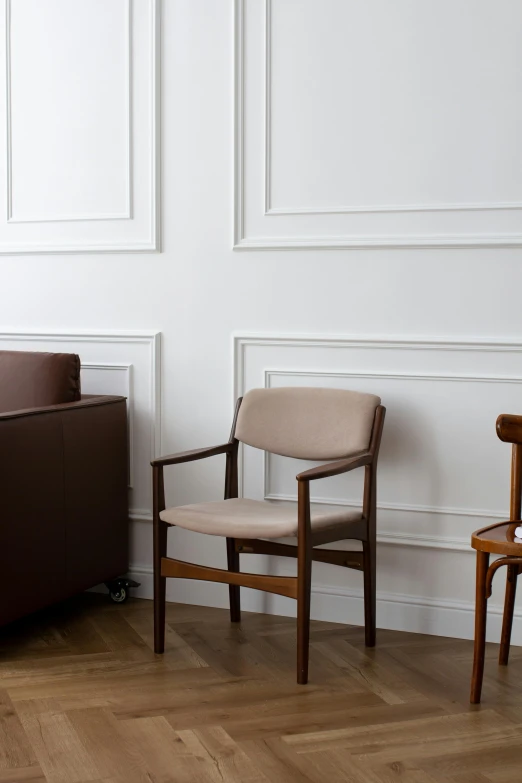 two wooden chairs on the floor next to each other