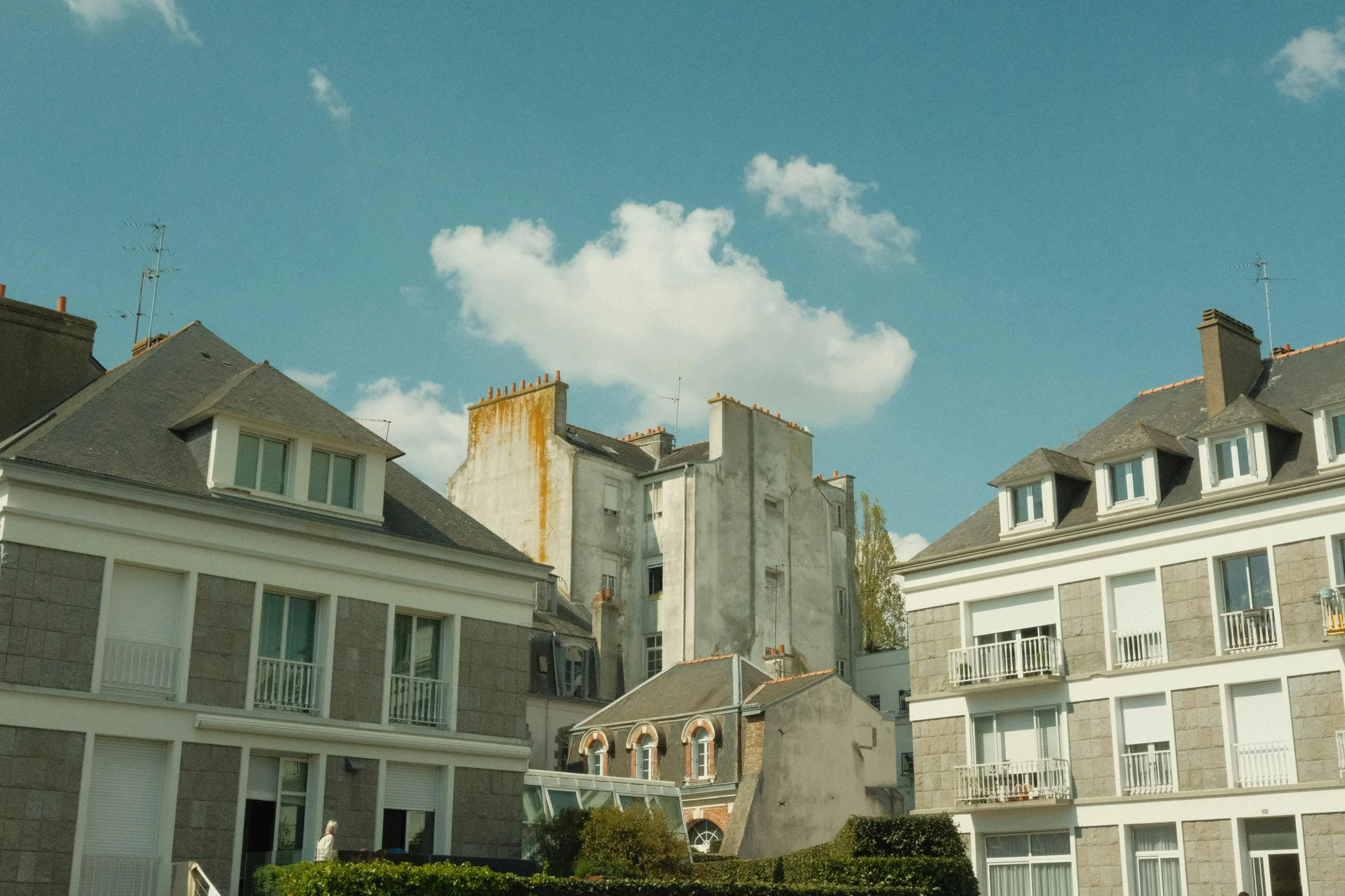 many white houses and towers against a blue sky