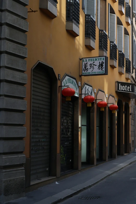 a corner store has red lanterns hanging from it