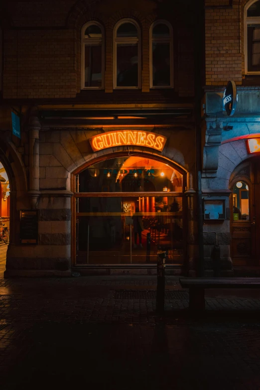 the front of a restaurant with neon lights at night