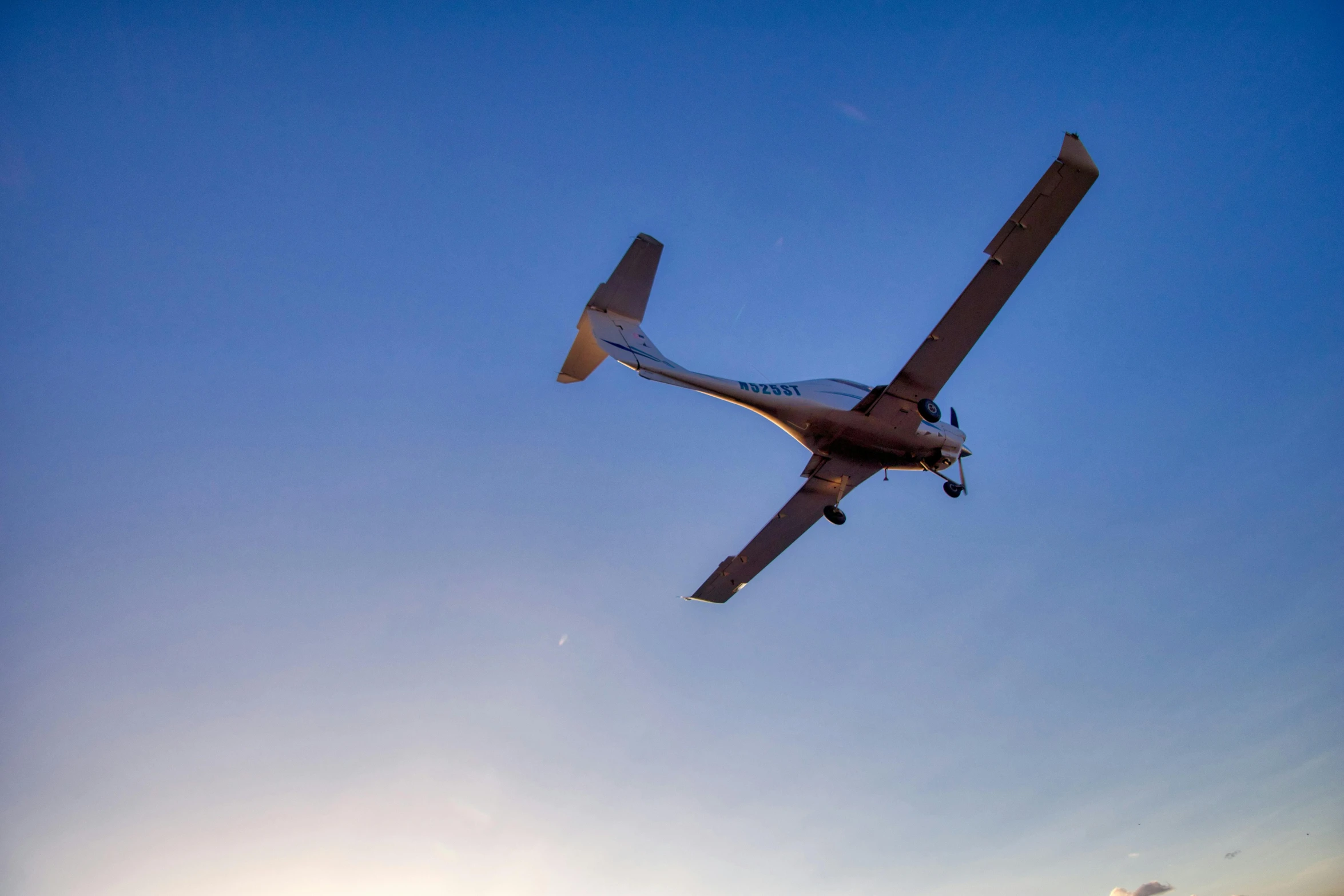 a single engine plane flying above on a clear day