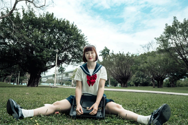 a woman that is sitting on the ground with some luggage