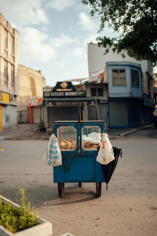 an old fashioned street vendor cart with bags on the front