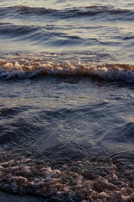 water splashing in to the ocean and on to the shore