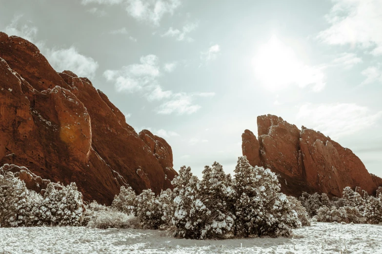 the sun is coming in from behind some rocks