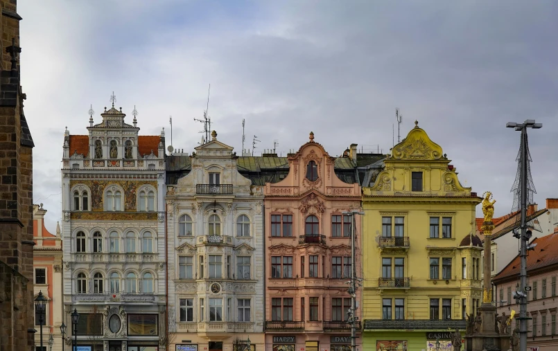 many colorful buildings on a street with a tall clock tower