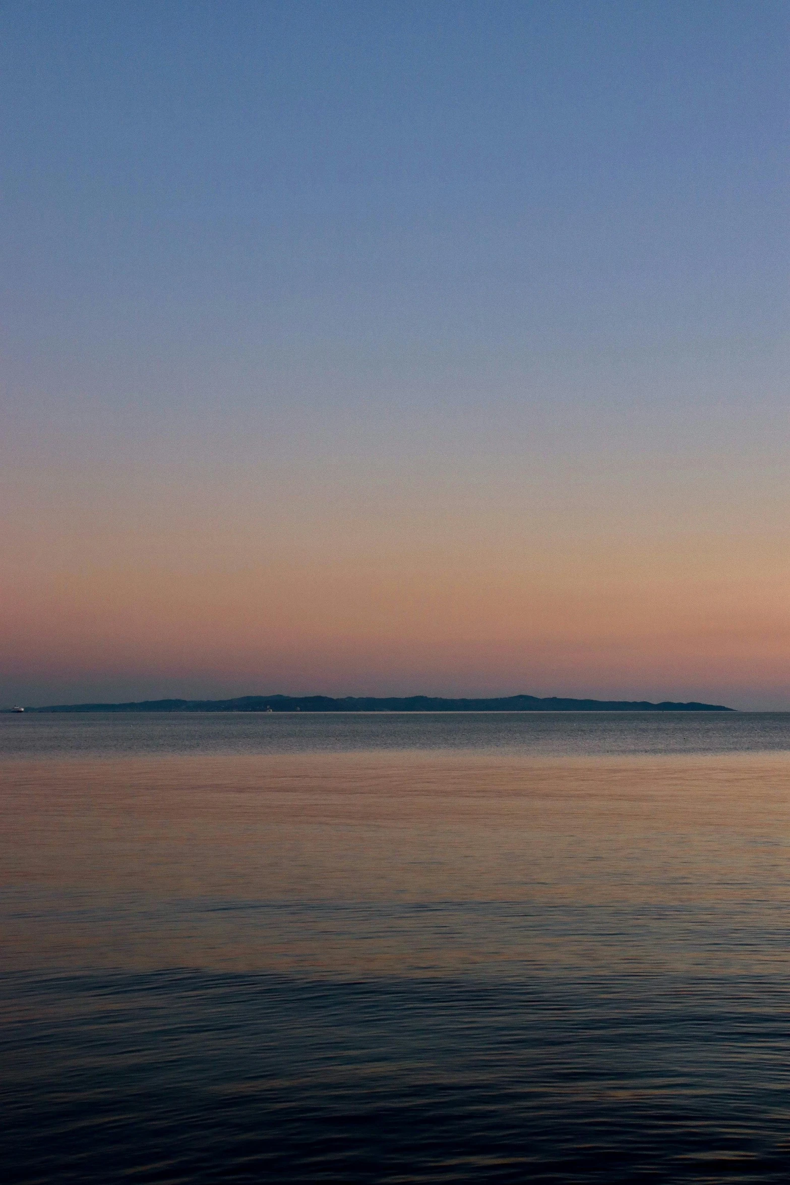 a boat is out in the water at dusk