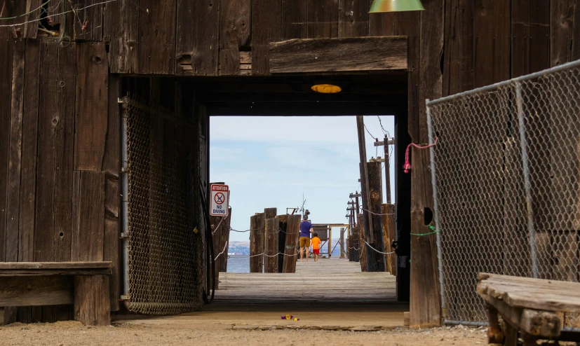 a doorway that leads to a pier with several benches