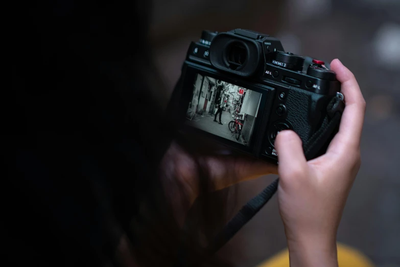 a woman taking a picture with an old camera