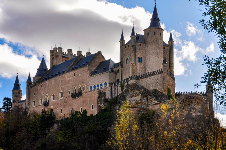 the huge castle has towers and spires on top