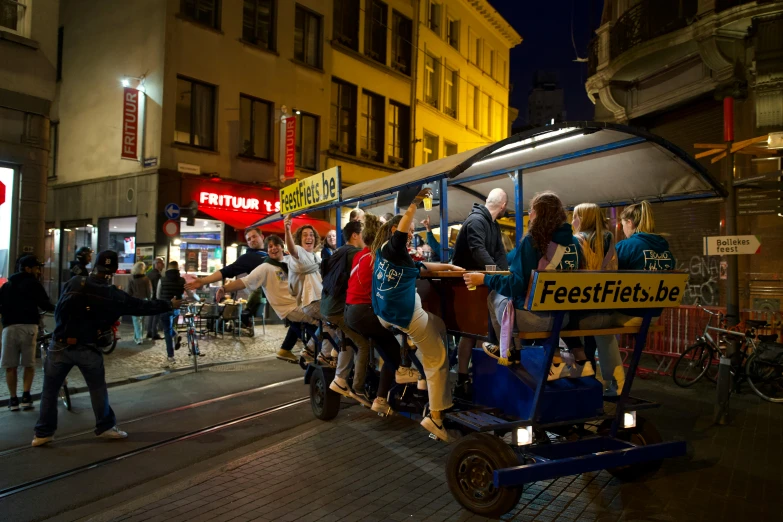 several people are riding an attraction on the city street