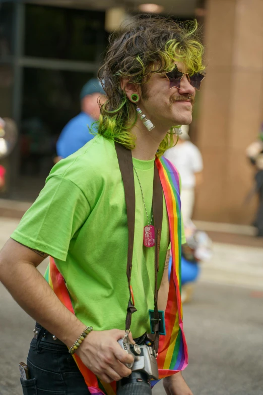 the man has curly hair with green makeup