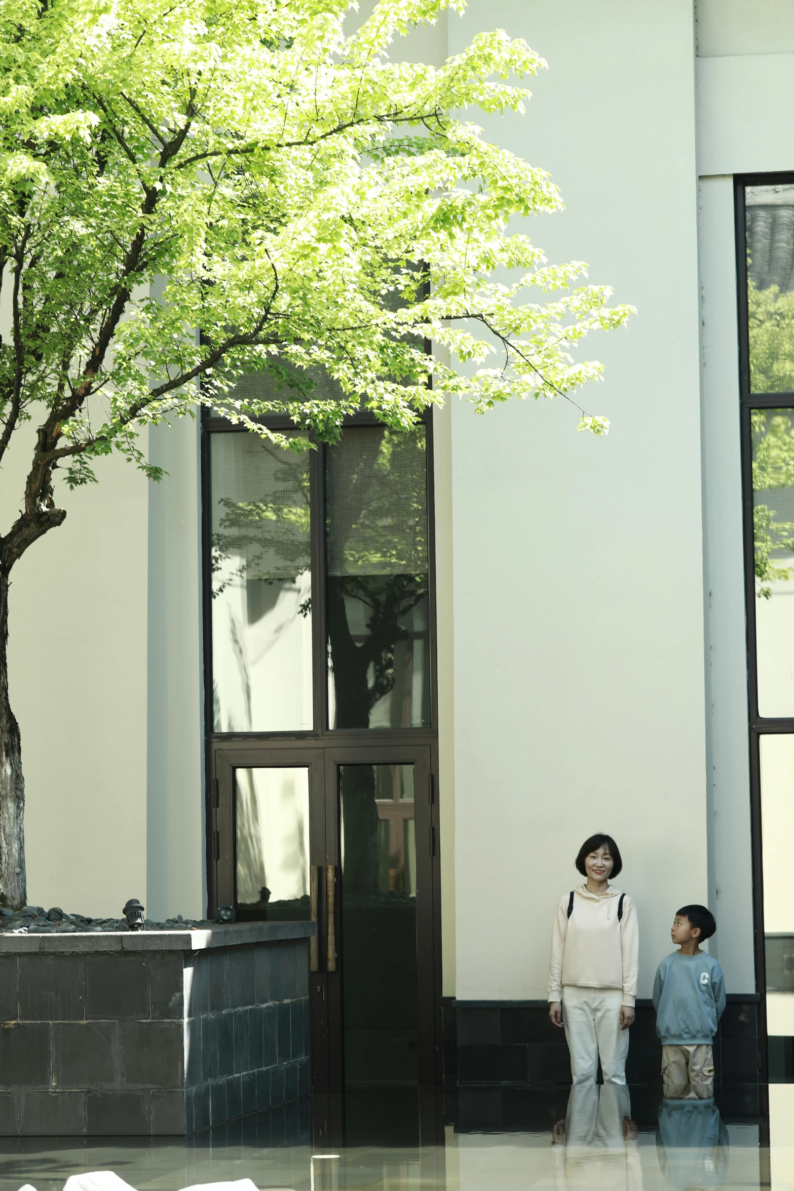 a pair of people standing in front of a building