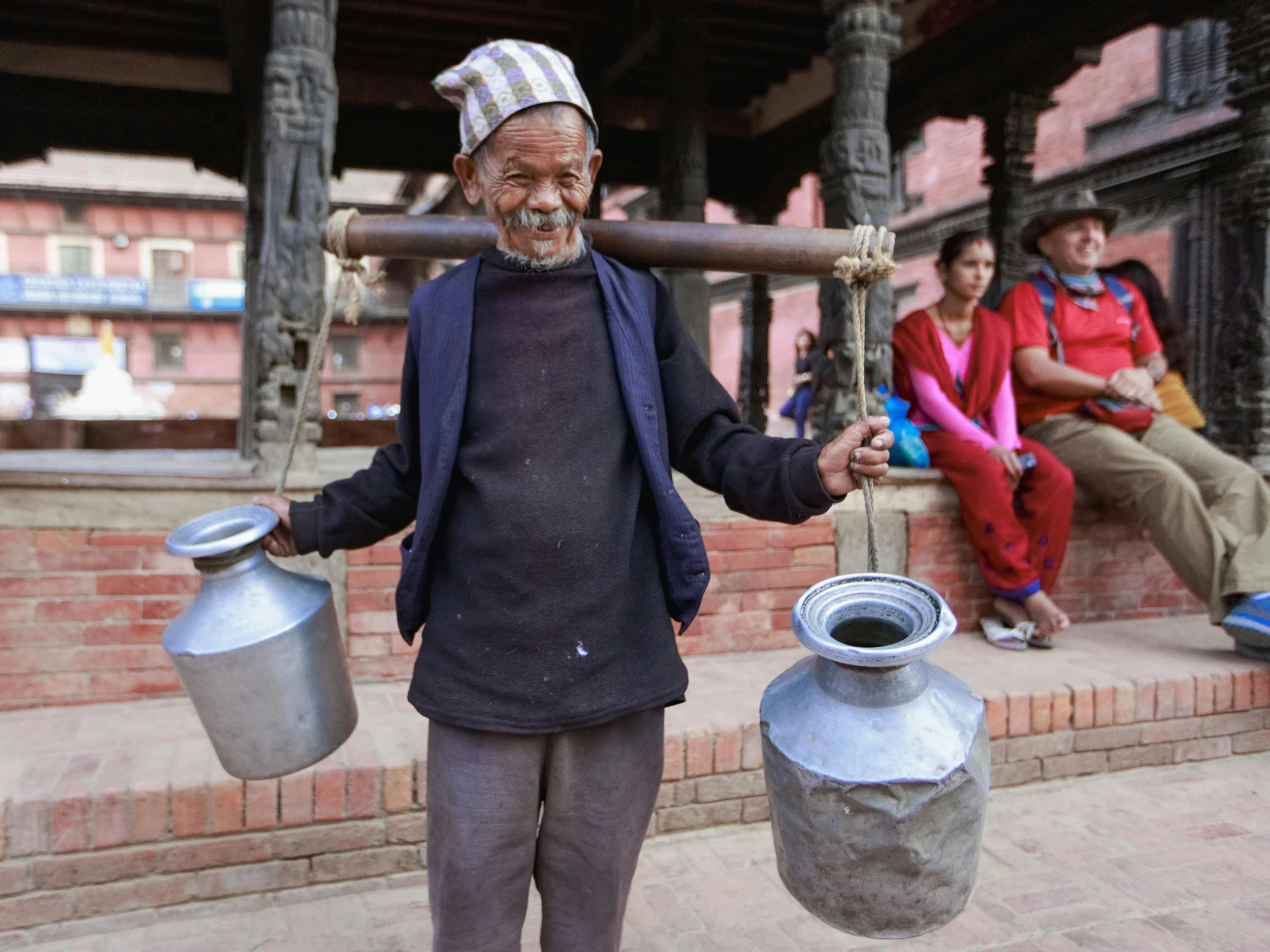 a man holding a large metal jug