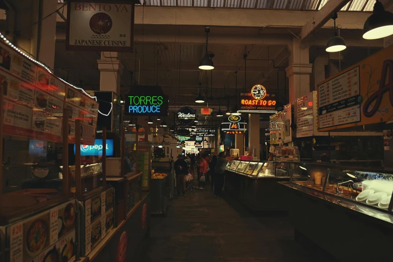 people walking around inside of a food court