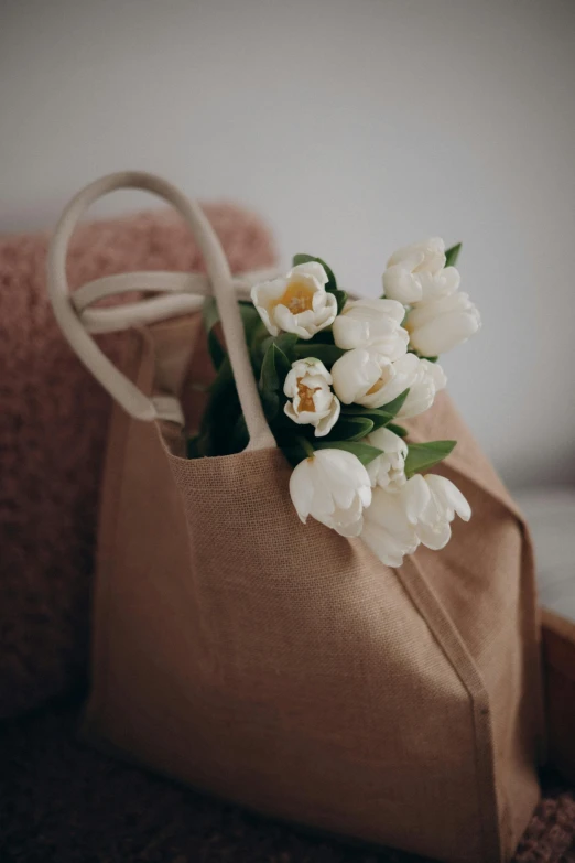 a tan cloth bag with tulips on it