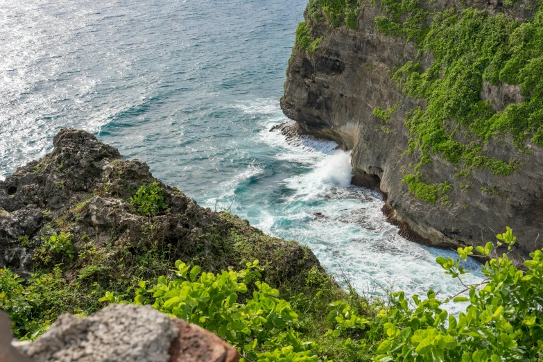 water coming out from an ocean near a cliff