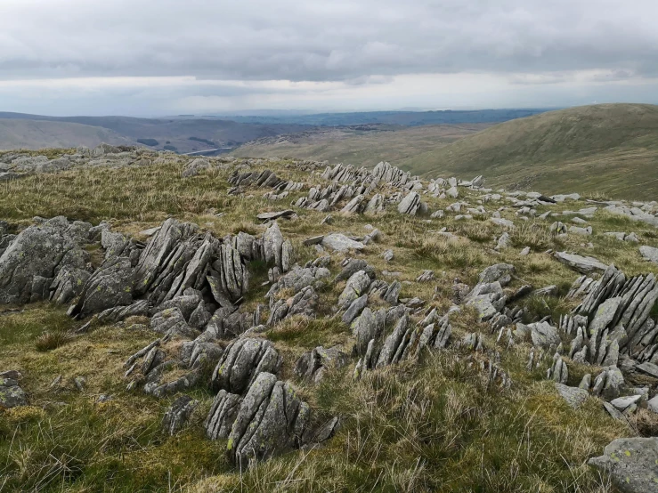 a rocky mountain landscape with grassy grass and rocks