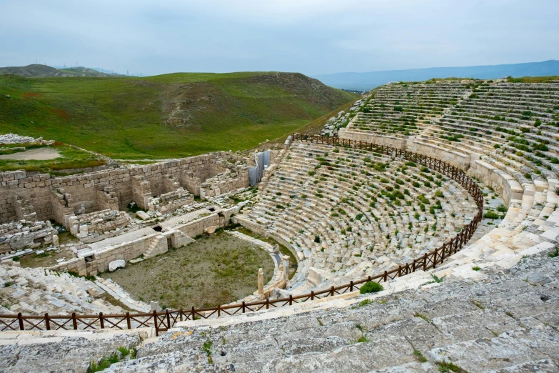 an abandoned theater sitting in the middle of a large field