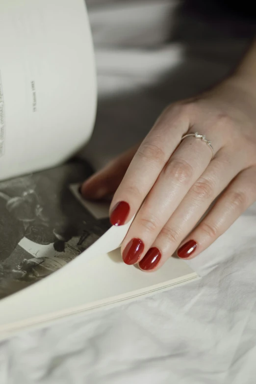 a hand holding a book and pressing on the pages