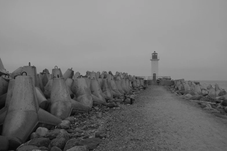 a view of an ocean front with a lighthouse in the distance