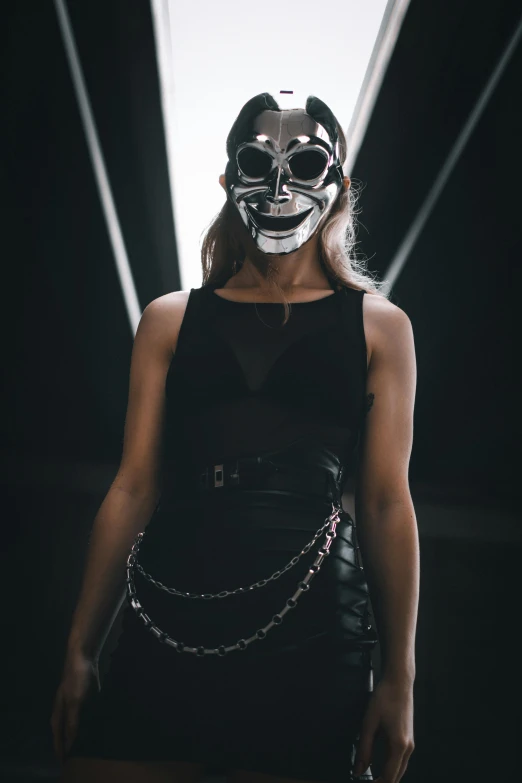 a woman wearing a mask and chain around her waist