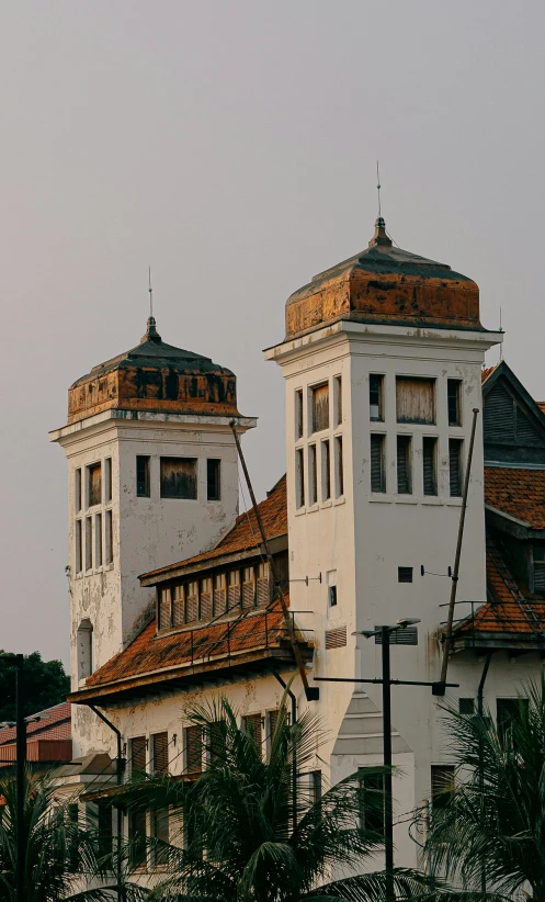 two buildings with a brown roof are seen from the outside