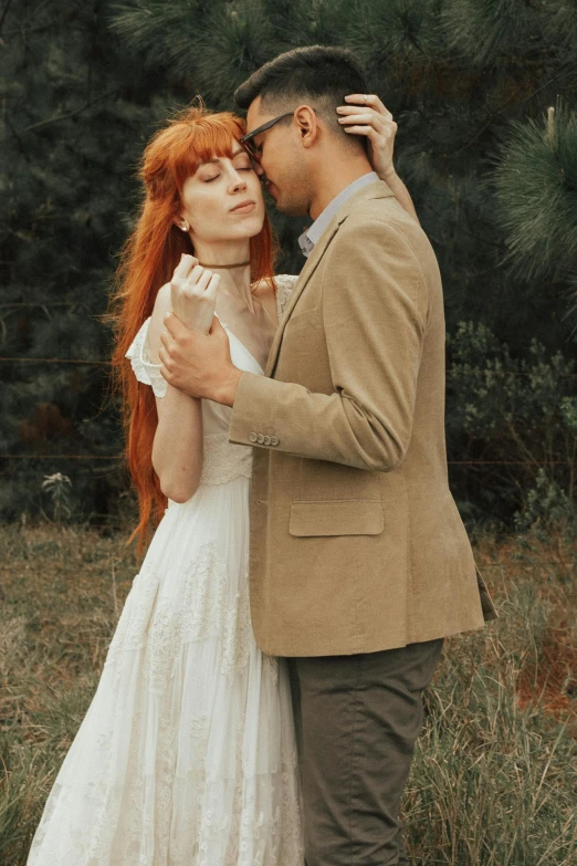 a couple standing close to each other on their wedding day