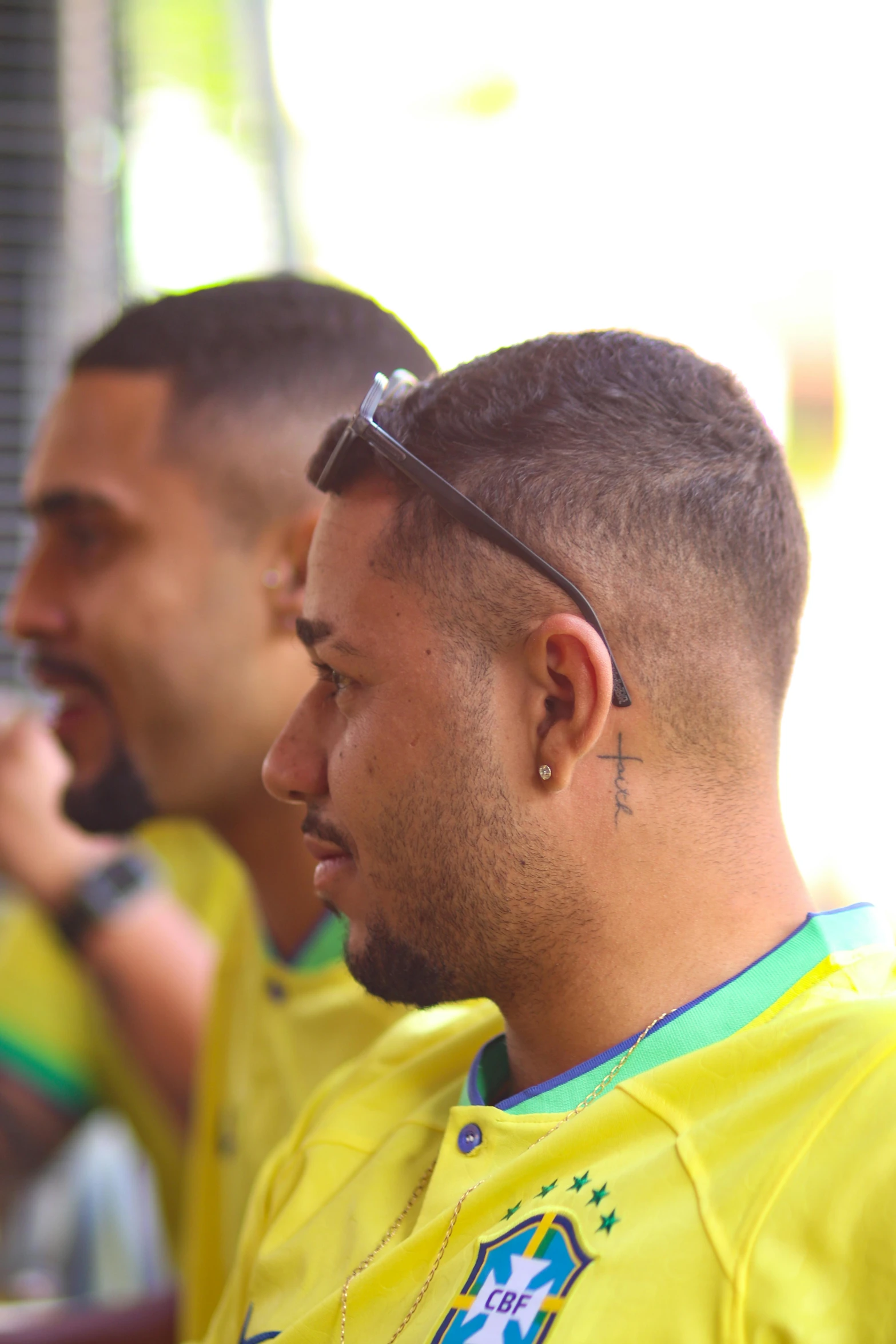 two young men with piercings are sitting next to each other