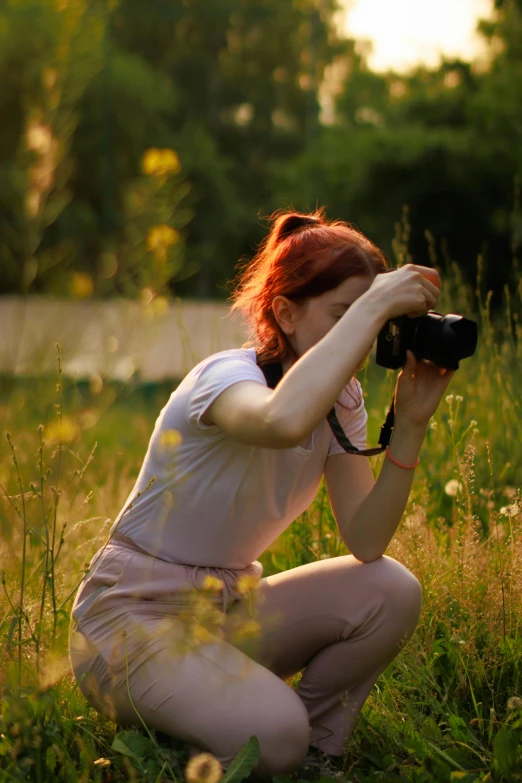 a woman taking a po of herself on the grass