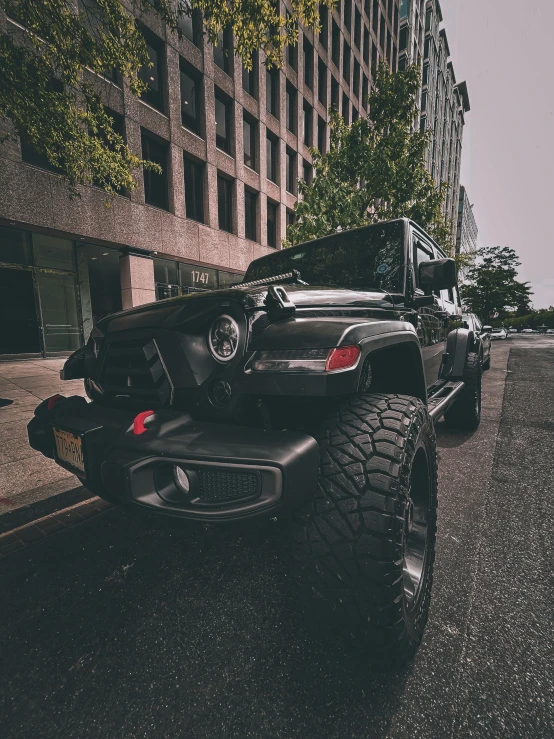 a jeep parked next to a large black vehicle