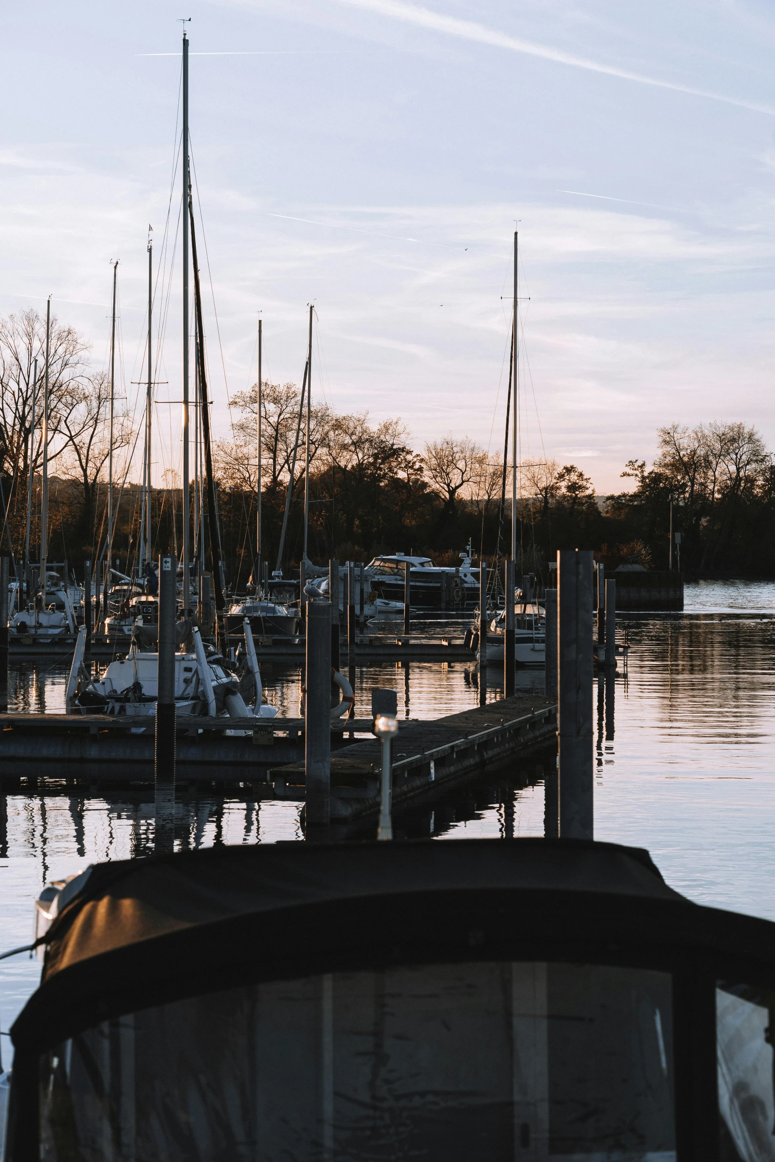 a boat sits docked at the end of a pier