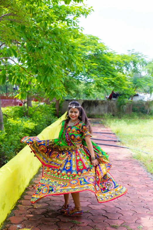 a woman dressed up in a dress by a fence