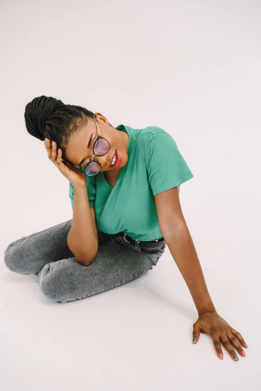 a woman with glasses on, is sitting down