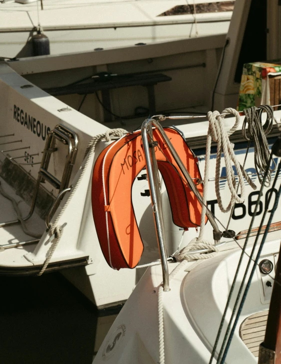 two white and orange boats docked in water