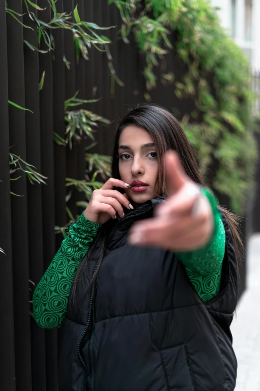 woman holding up her cellphone as she speaks on the phone