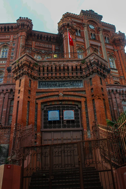 a large building has a fence with a gate in front of it