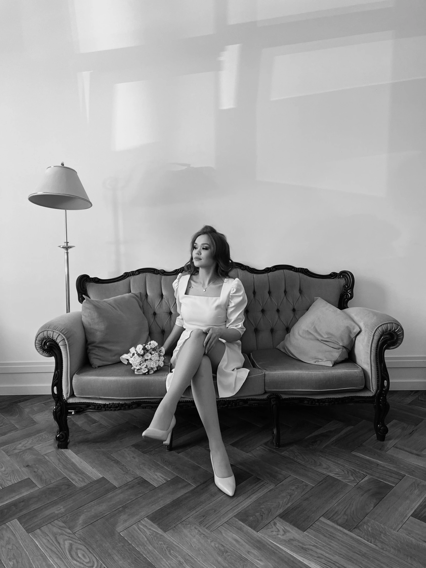 black and white po of a woman on a couch