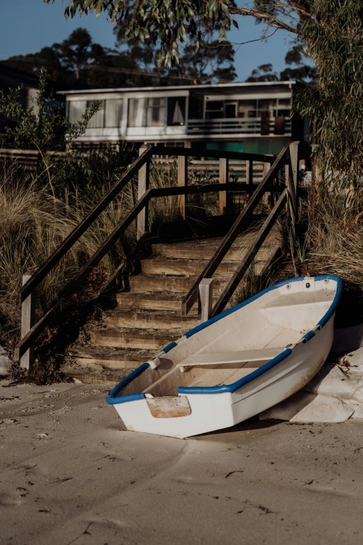 a rowboat is lying on the shore at low tide