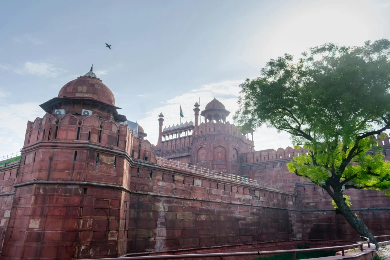 a large red brick building with many towers and clocks