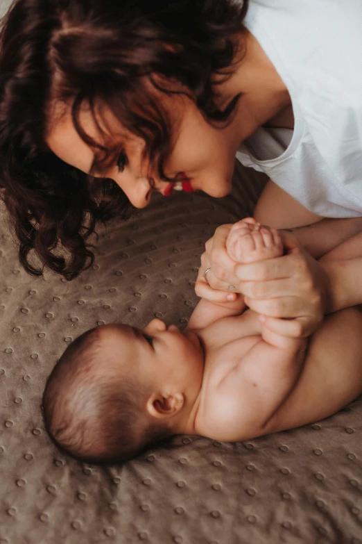 a woman feeds a baby with it's bottle